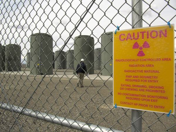 A warning sign posted on the chain link fence of nuclear power plant.