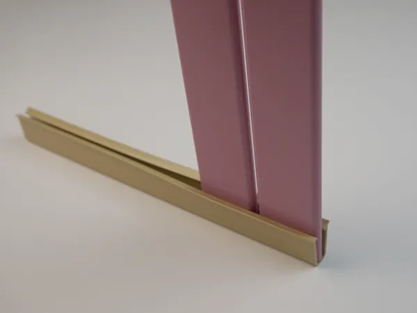 Pink tubular chain link fence slats installed on the bottom slat