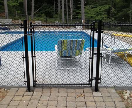 Chain link fence is installed surround the swimming pool.