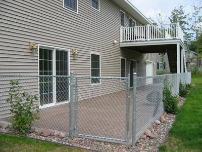 Galvanized residential fence with single walk gate.