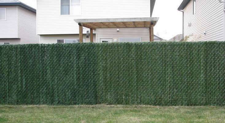 Hedge slat privacy fence for a residential area.