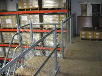 Galvanized stair chain link railing used in warehouse.