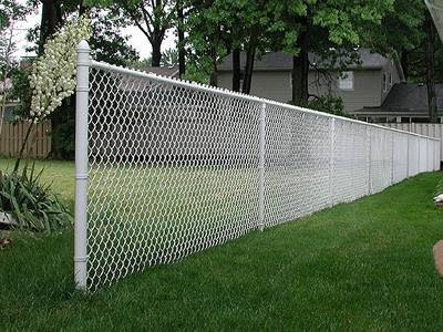 White vinyl-coated chain link fence for residential area.